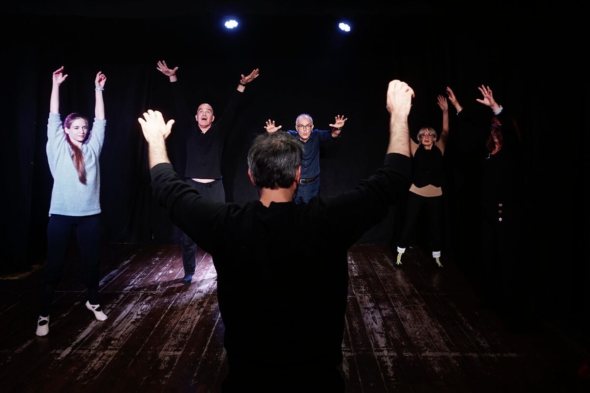 Ivano leading a workshop -- ensemble in movement with arms raised